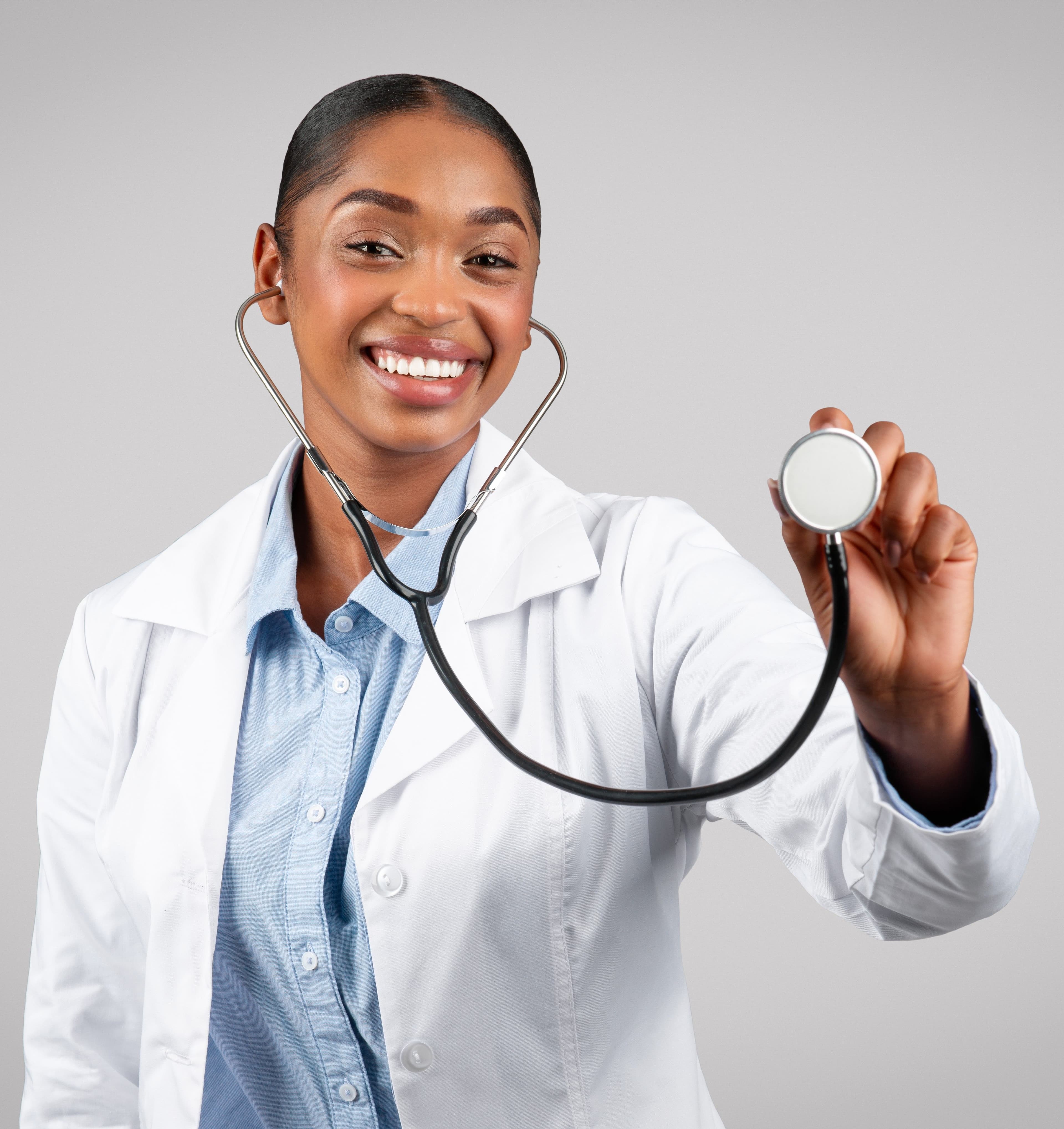 a smiling female doctor is holding a stethoscope in her hand .